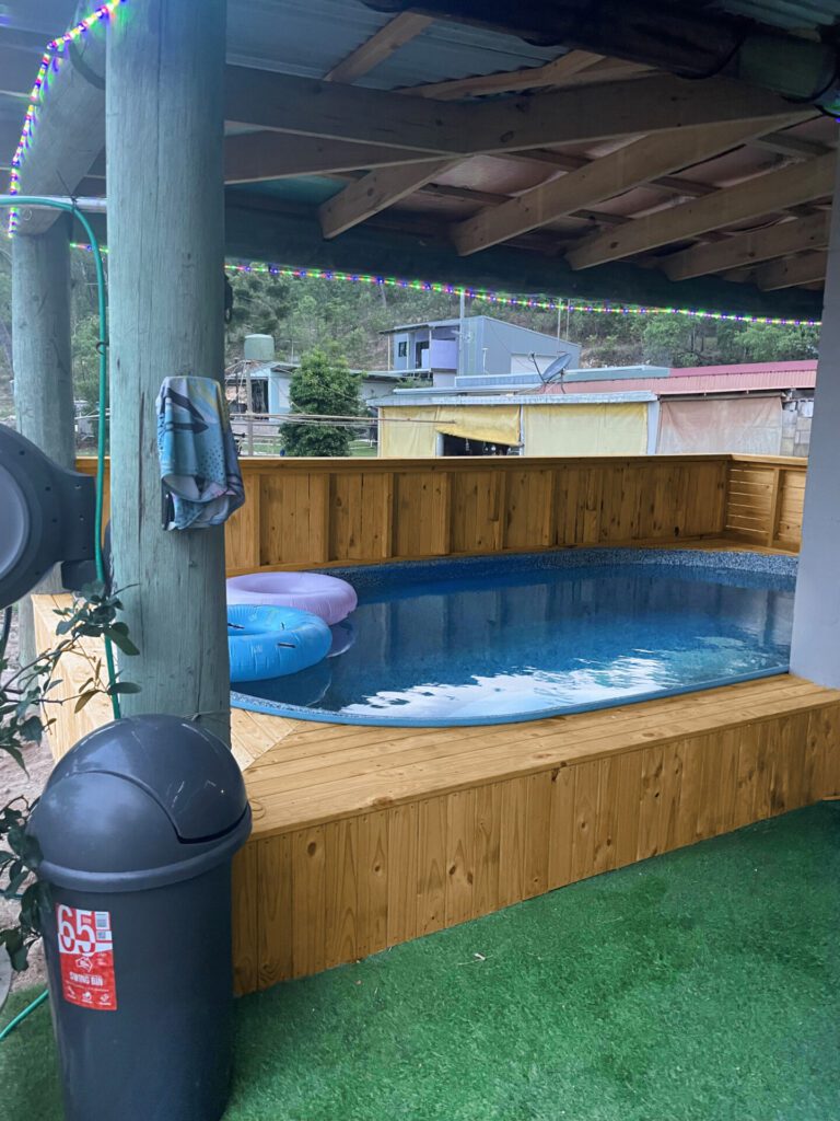 Schooner Swimming Pool in backyard Wooden Pool deck