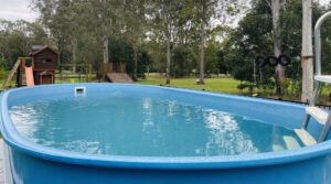 Schooner Swimming Pool in long yard photo sitting on concrete slab