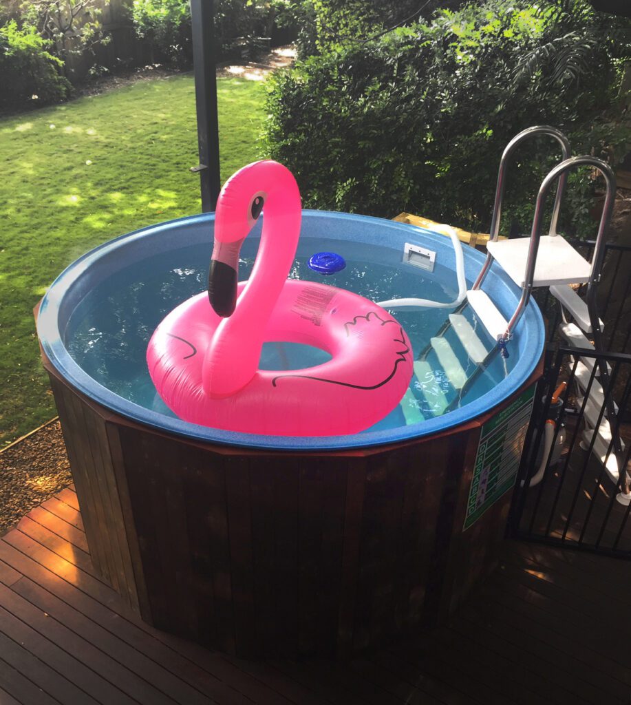 Tug Swimming Pool with wooden deck bounding and a large inflatable Flamingo