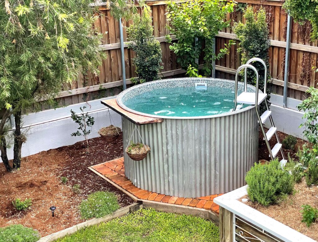 Tug Above Ground Pool sitting on bricks with corrugated iron wrapping