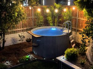 Tug Swimming Pool at night with scenic overhead lights